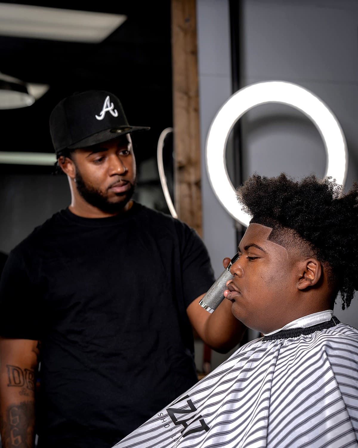 Daniel Brown shaping a beard lineup with clippers at Vanzant