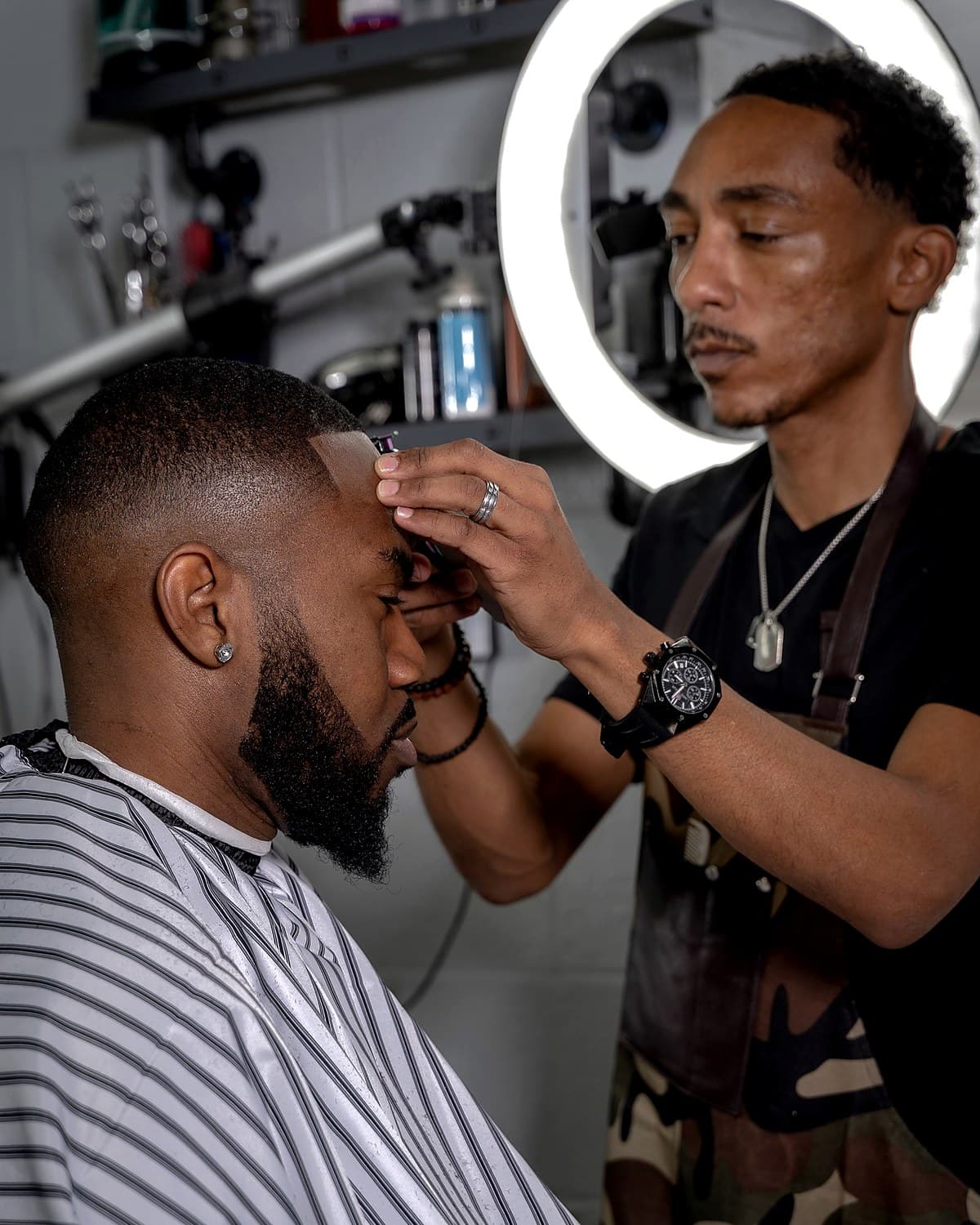 Steve Vanzant lining up a client in the chair at Vanzant Barbershop Lounge in Tupelo