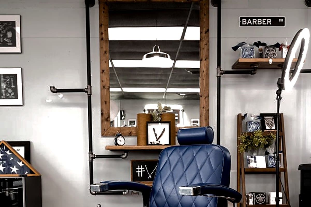 Empty blue barber chair ready for the next client at Vanzant
