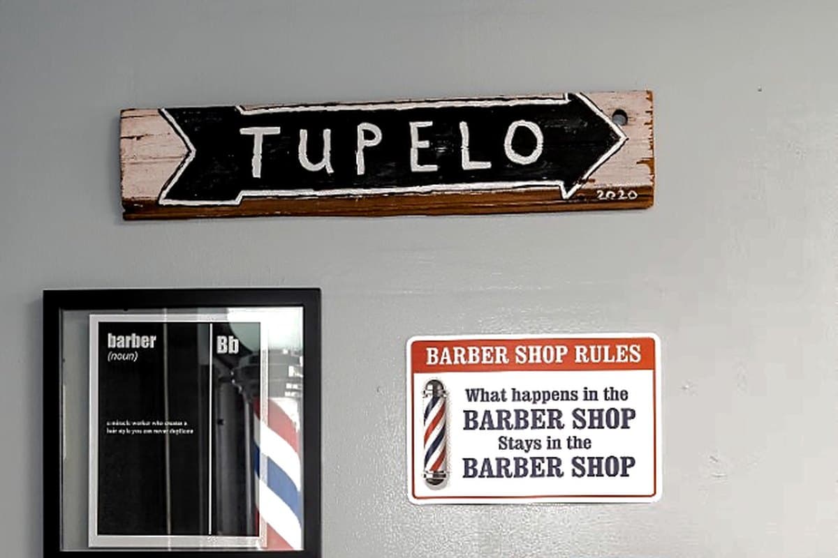 Tupelo wall sign and barbershop décor at Vanzant Barbershop Lounge