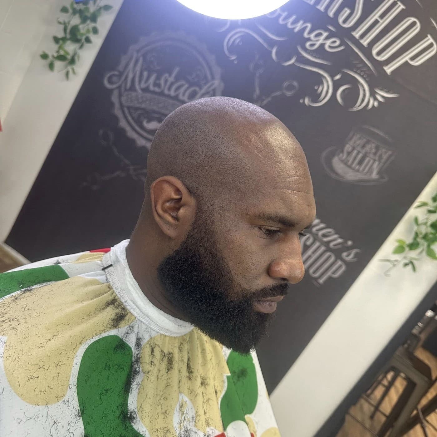Shaved head with precision beard lineup after hot towel work