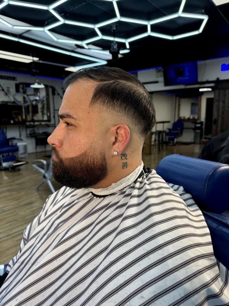 Side-part comb-over with clean fade and sculpted beard Side-part comb-over with clean fade and sculpted beard