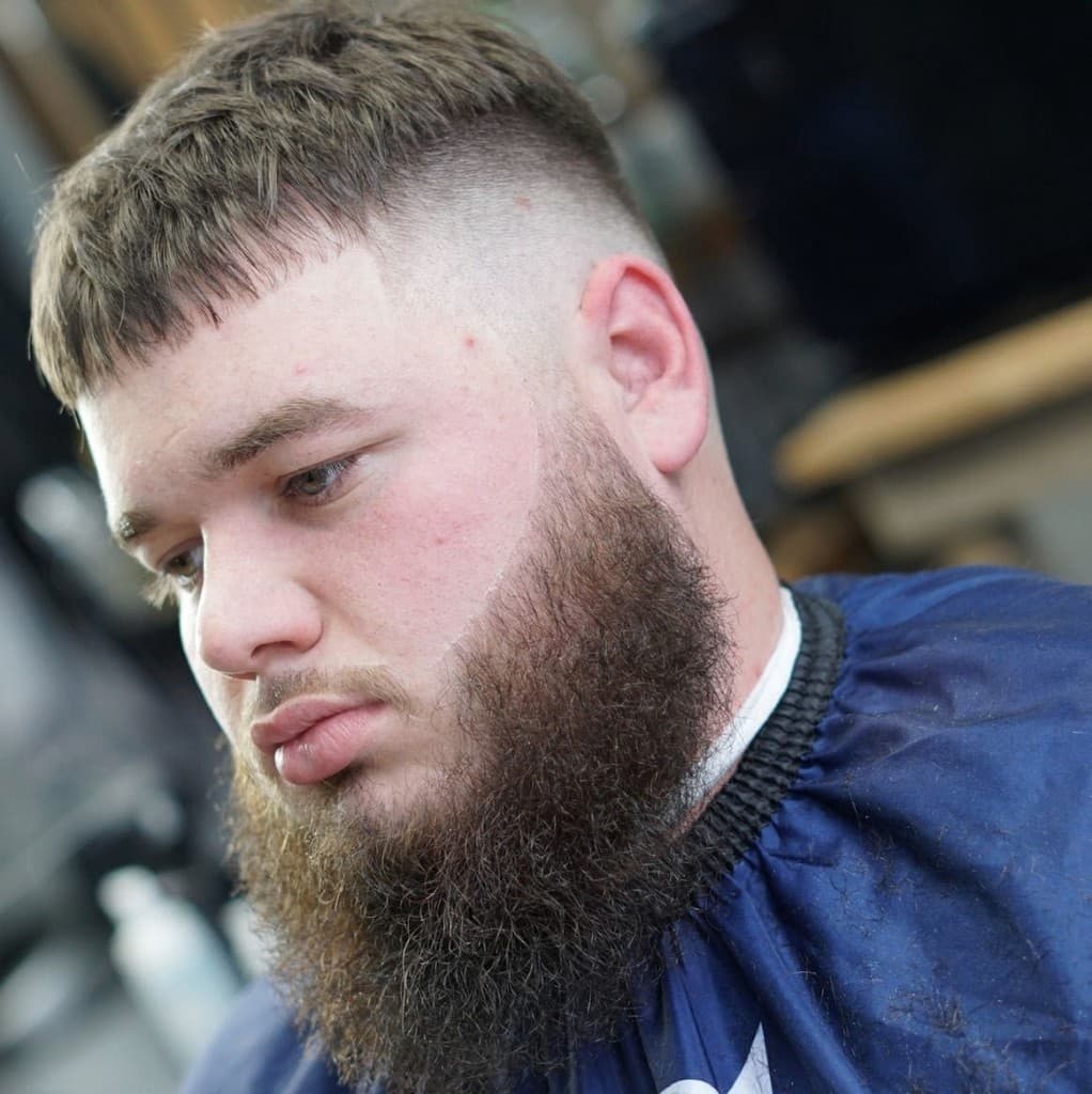 Textured French crop with high skin fade and groomed beard