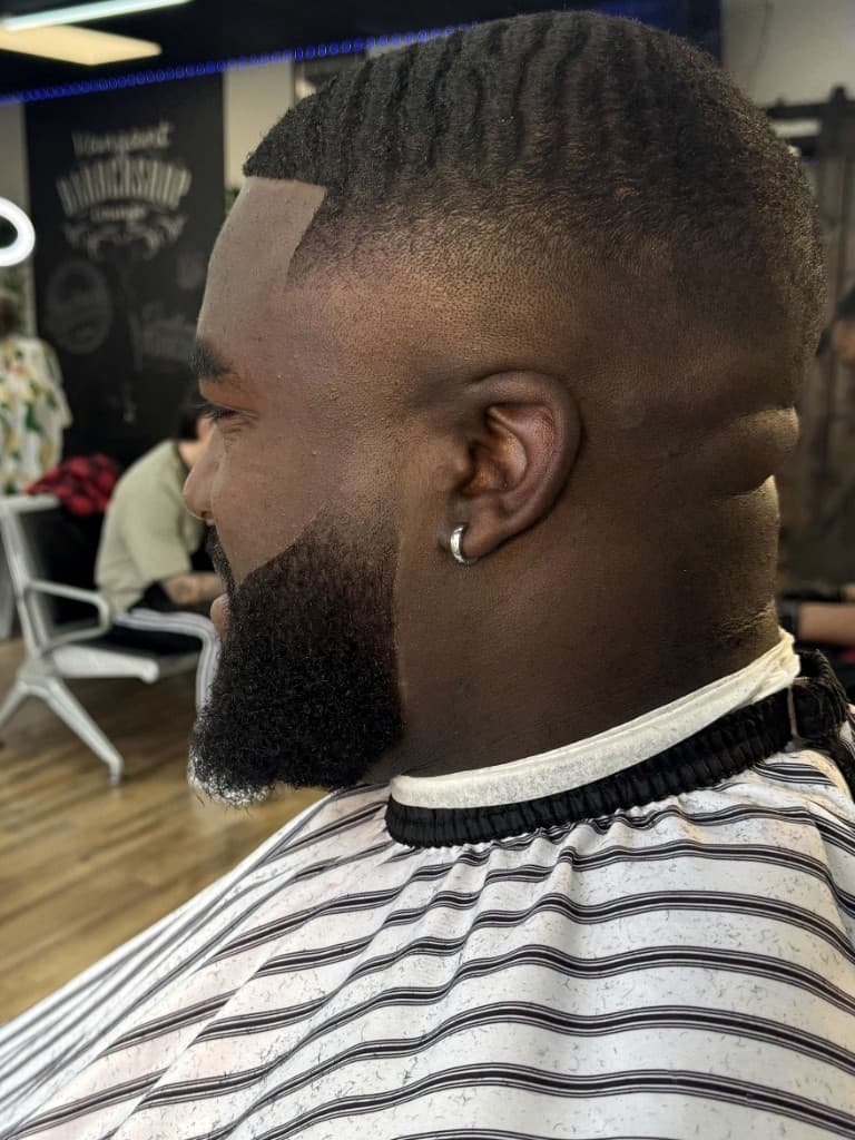 Waves with skin fade, crisp lineup, and sculpted beard Waves with skin fade, crisp lineup, and sculpted beard