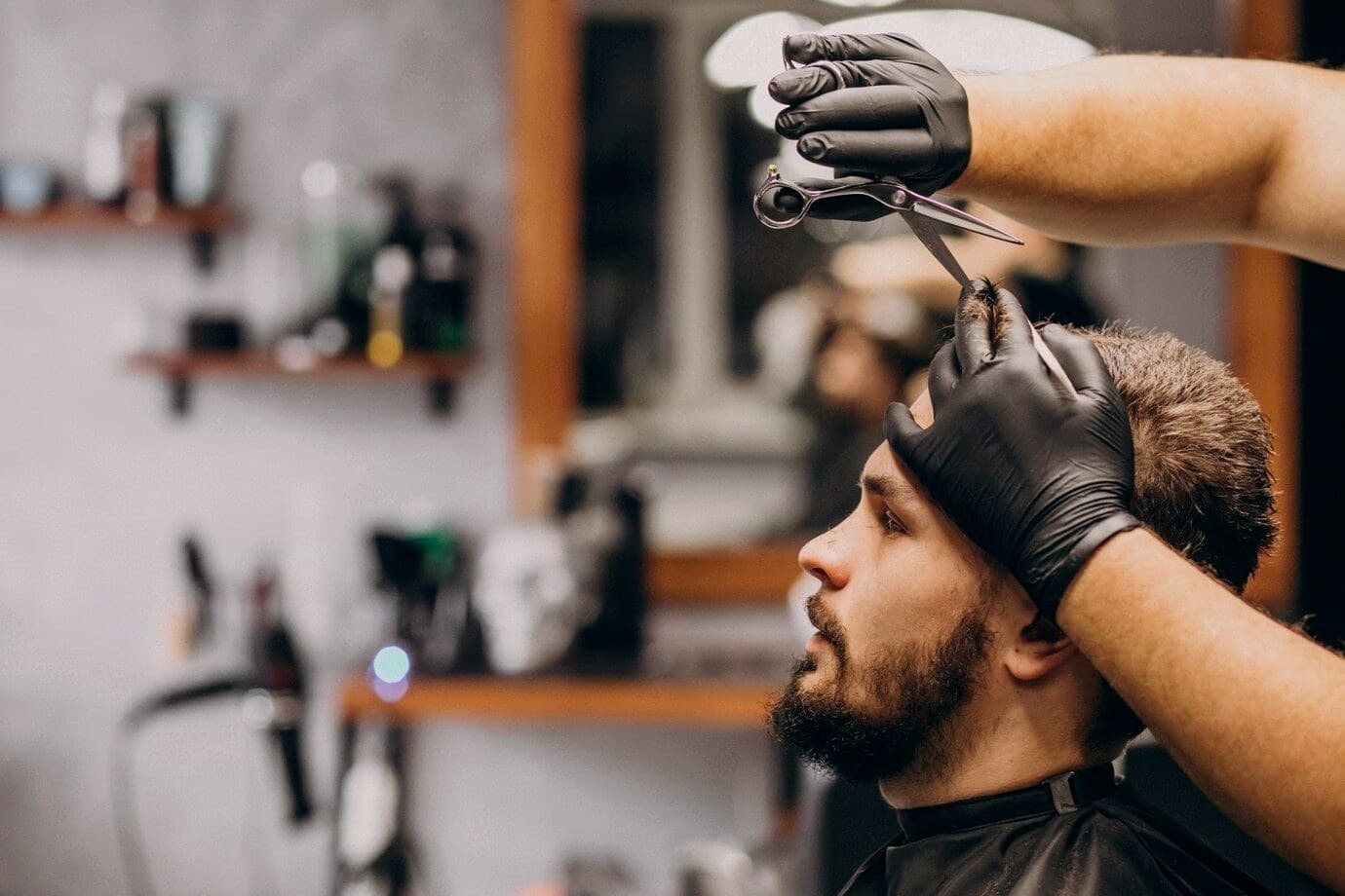 Close-up of scissors and comb cutting hair at a Vanzant barber station