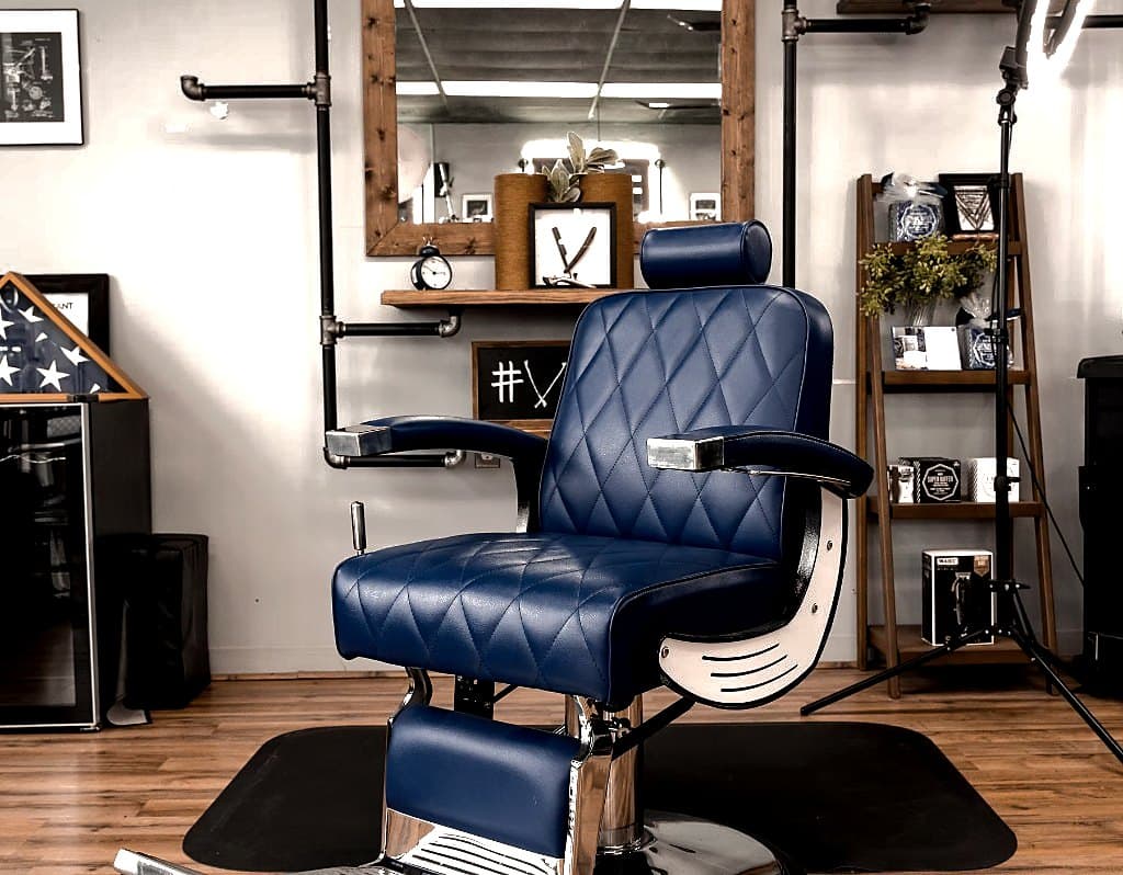 Blue diamond-quilted barber chair at Vanzant Barbershop Lounge in Tupelo