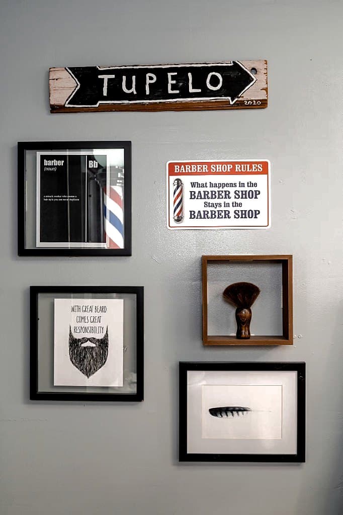 Tupelo wall sign and barbershop décor at Vanzant Barbershop Lounge