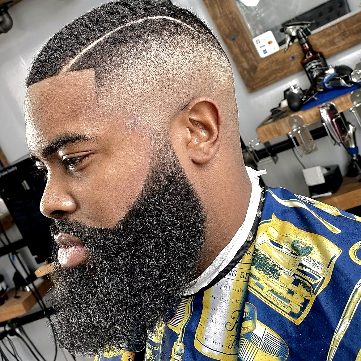 Hard part fade with razor-sharp beard cheek lines