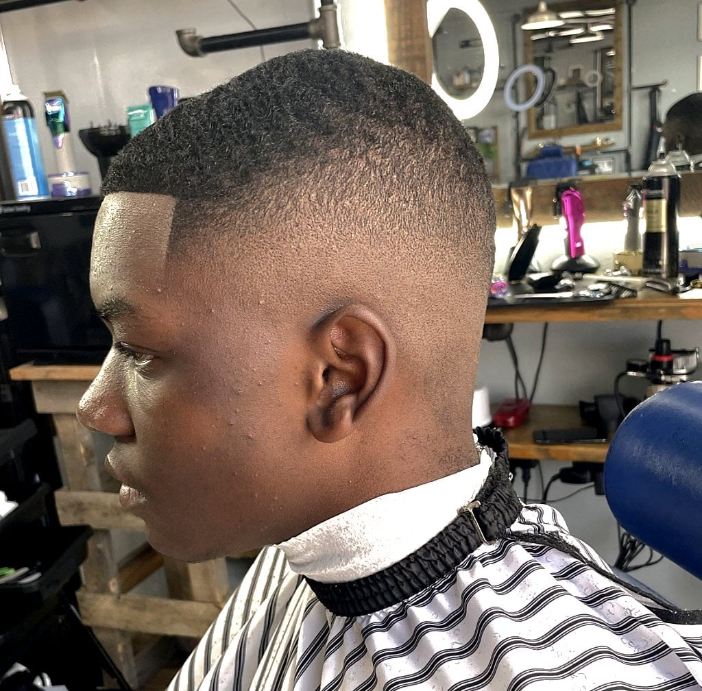 Tight curls with mid skin fade and razor-sharp lineup