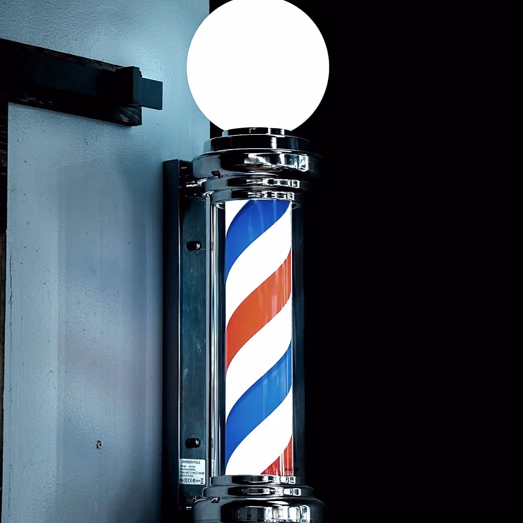 Classic illuminated barber pole at Vanzant Barbershop Lounge