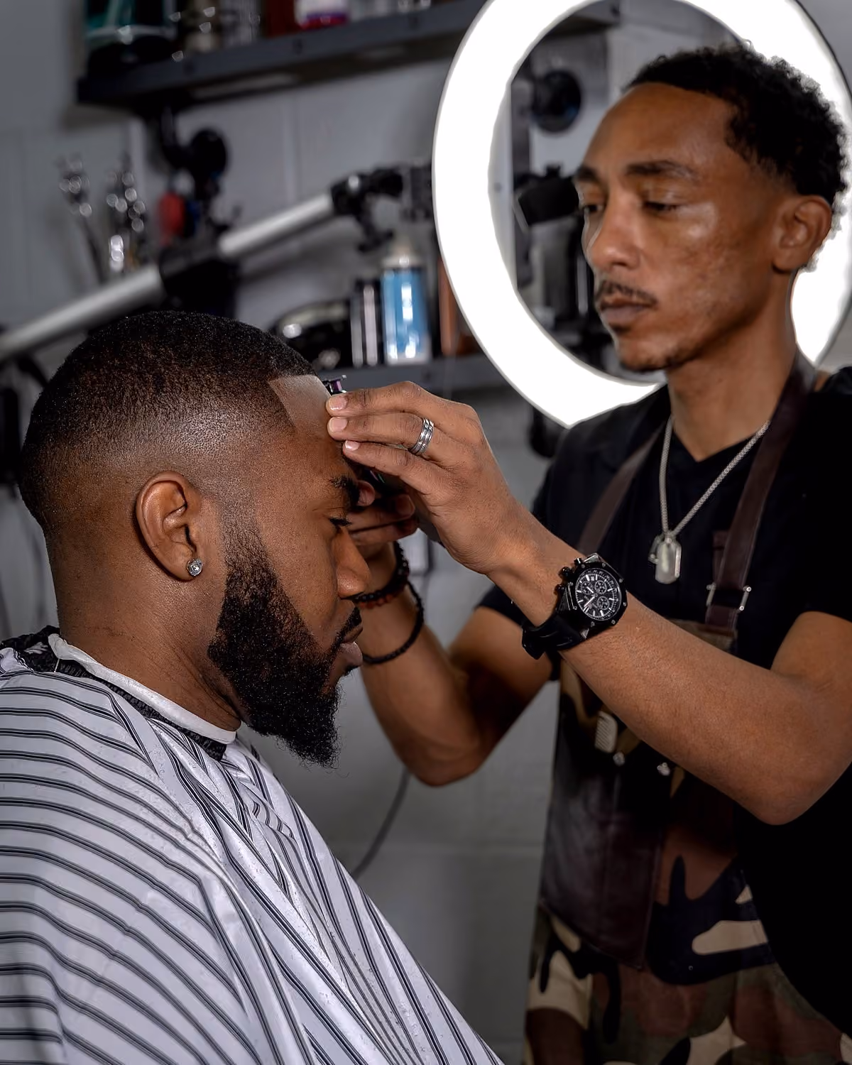 Steve Vanzant lining up a client in the chair at Vanzant Barbershop Lounge