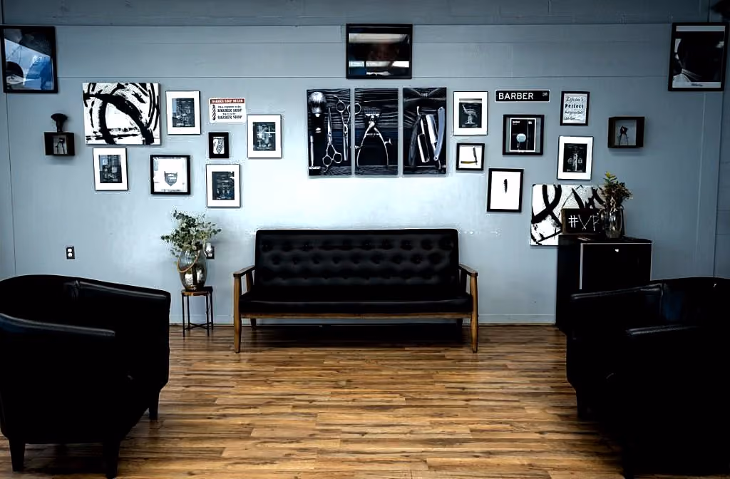 Waiting lounge with black leather seating and gallery wall at Vanzant