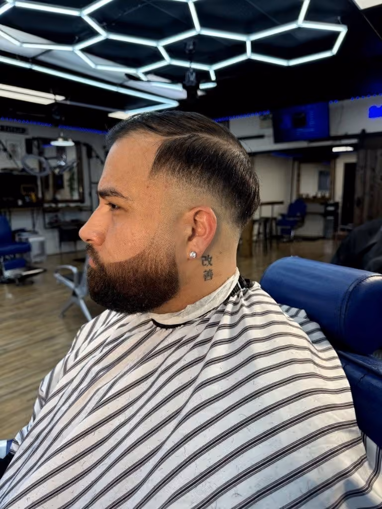 Side-part comb-over with clean fade and sculpted beard Side-part comb-over with clean fade and sculpted beard