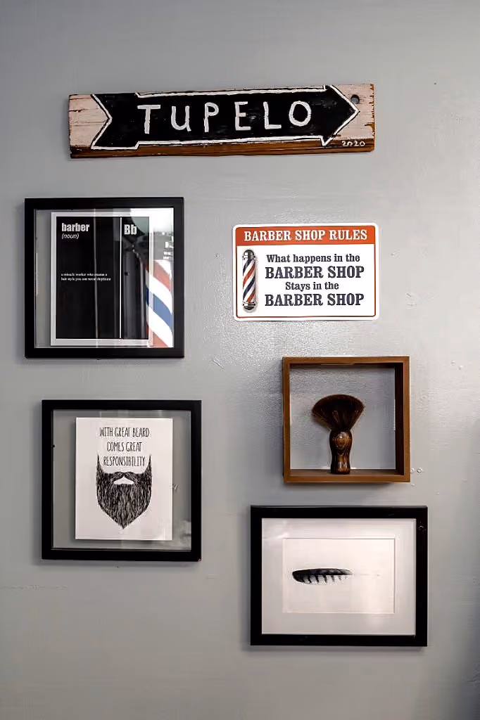 Tupelo wall sign and barbershop décor at Vanzant Barbershop Lounge