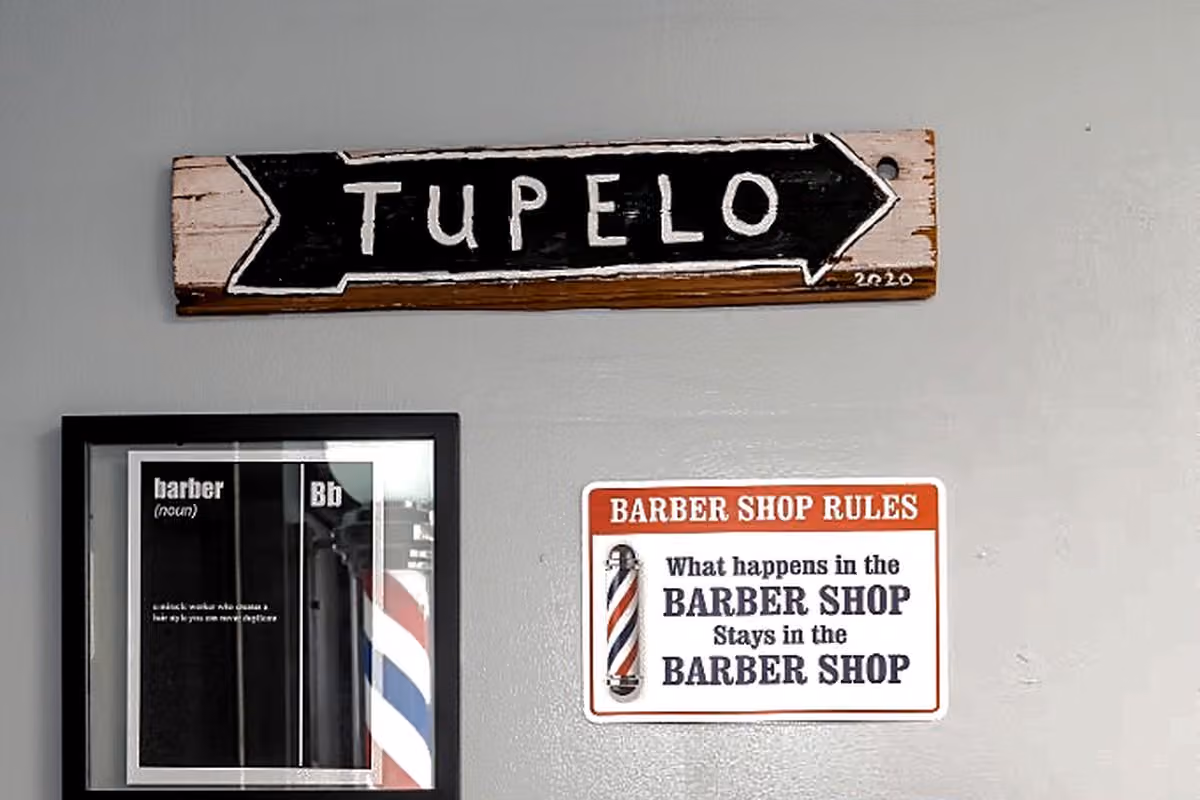 Tupelo wall sign and barbershop décor at Vanzant Barbershop Lounge